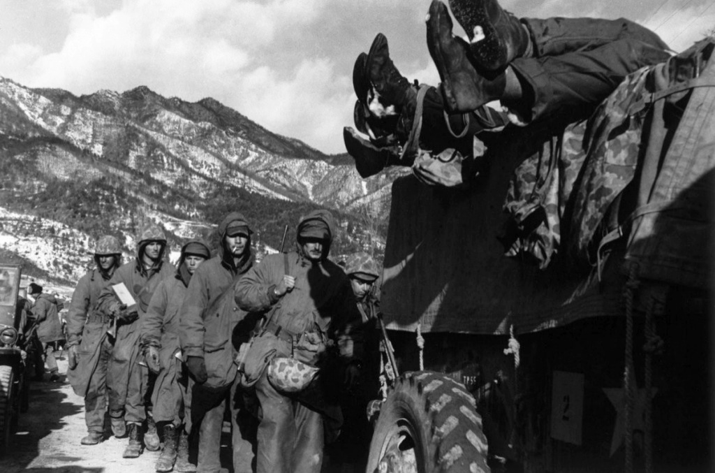 Marines File Past a Truck Load with Dead Troops during Retreat from Chosin Reservoir