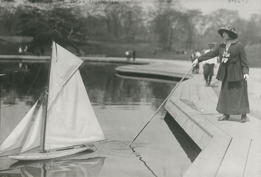 Woman Launches a Toy Yacht in Central Park, New York City