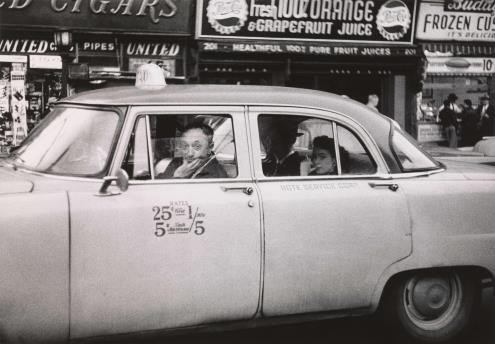 Diane Arbus (1923-1971).  Taxi driver at the wheel with two passengers, N.Y.C. 1956 (© The Estate of Diane Arbus, LLC. All Rights Reserved)