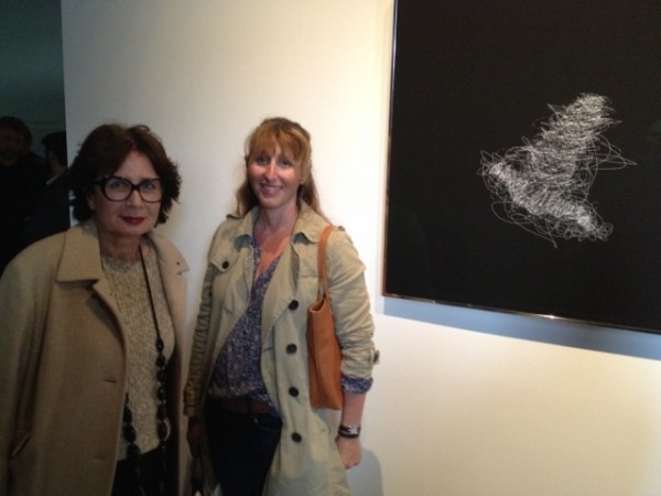 Francoise Paviot and her associate in front of work by Barbara Steinman.