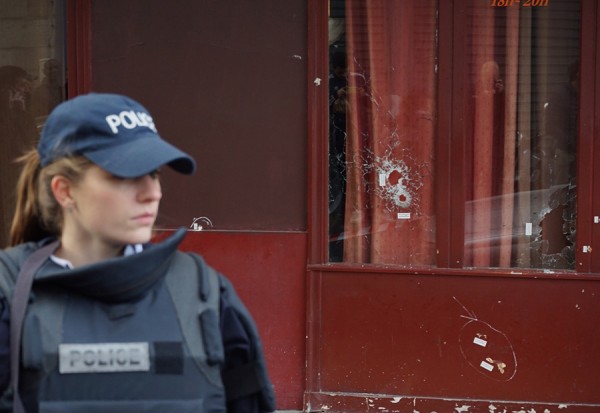Police and shot-up glass at another scene of one of the massacres in Paris at at the Carillion. (Photo courtesy and copyright 2015 by Steven Evans)