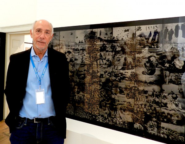 Howard Greenberg next to Matthias Olmeta's "Traite de Paix 1", an assemblage of 40 ambrotypes of atrocities in China and Vietnam. (Photo by Michael Diemar)