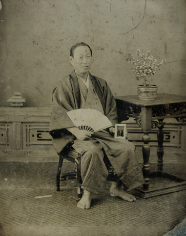 Anonymous - Japanese Man in Traditional Garb Holding Another Ambrotype of His Portrait in Western-Style Clothing